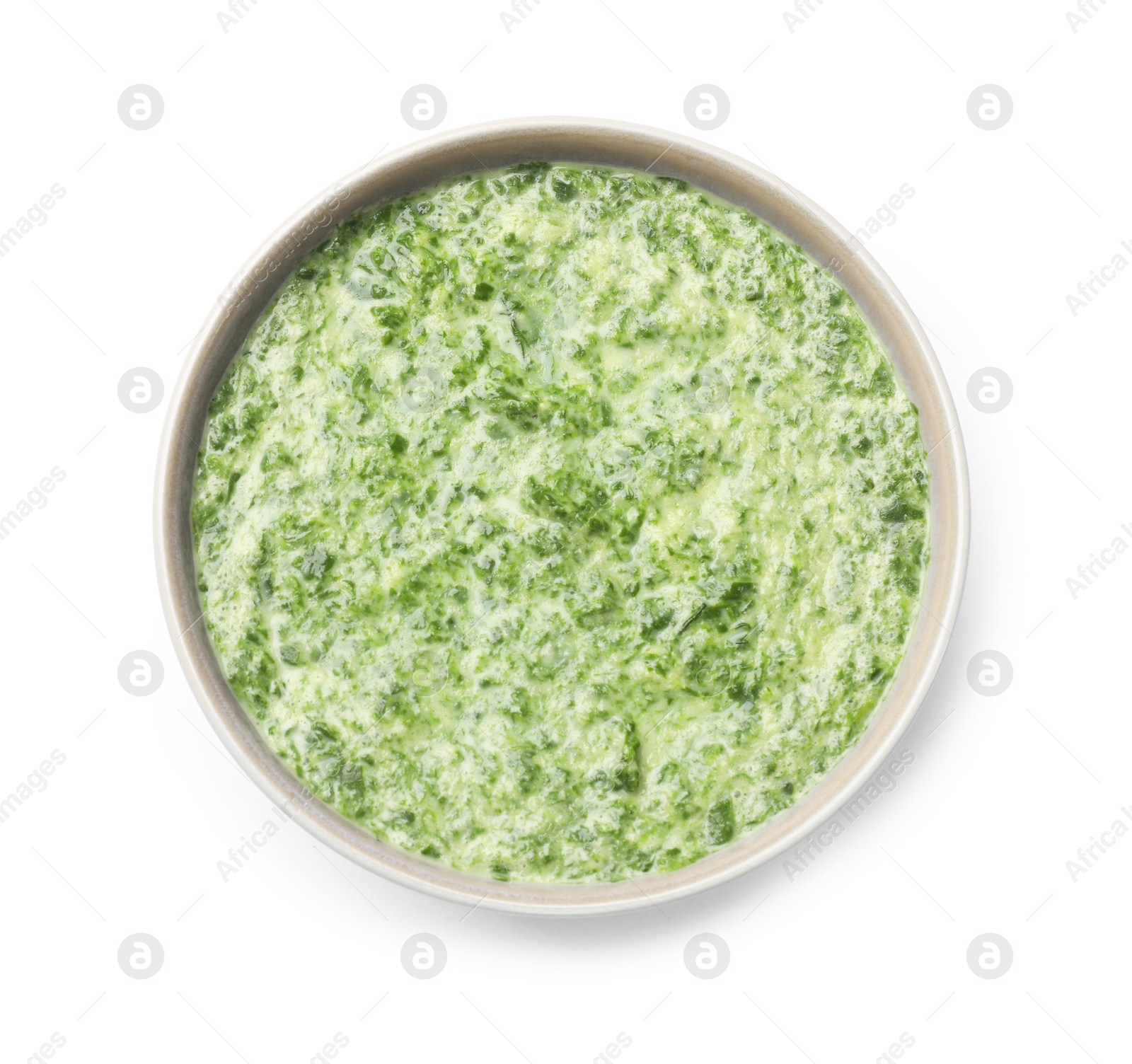 Photo of Delicious spinach sauce in bowl isolated on white, top view