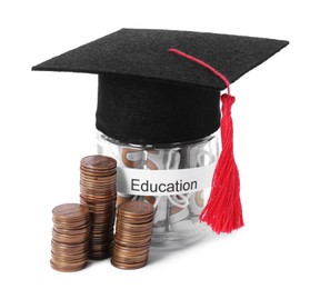 Photo of Graduate hat, coins and dollar banknotes in glass jar with word Education isolated on white. Tuition payment