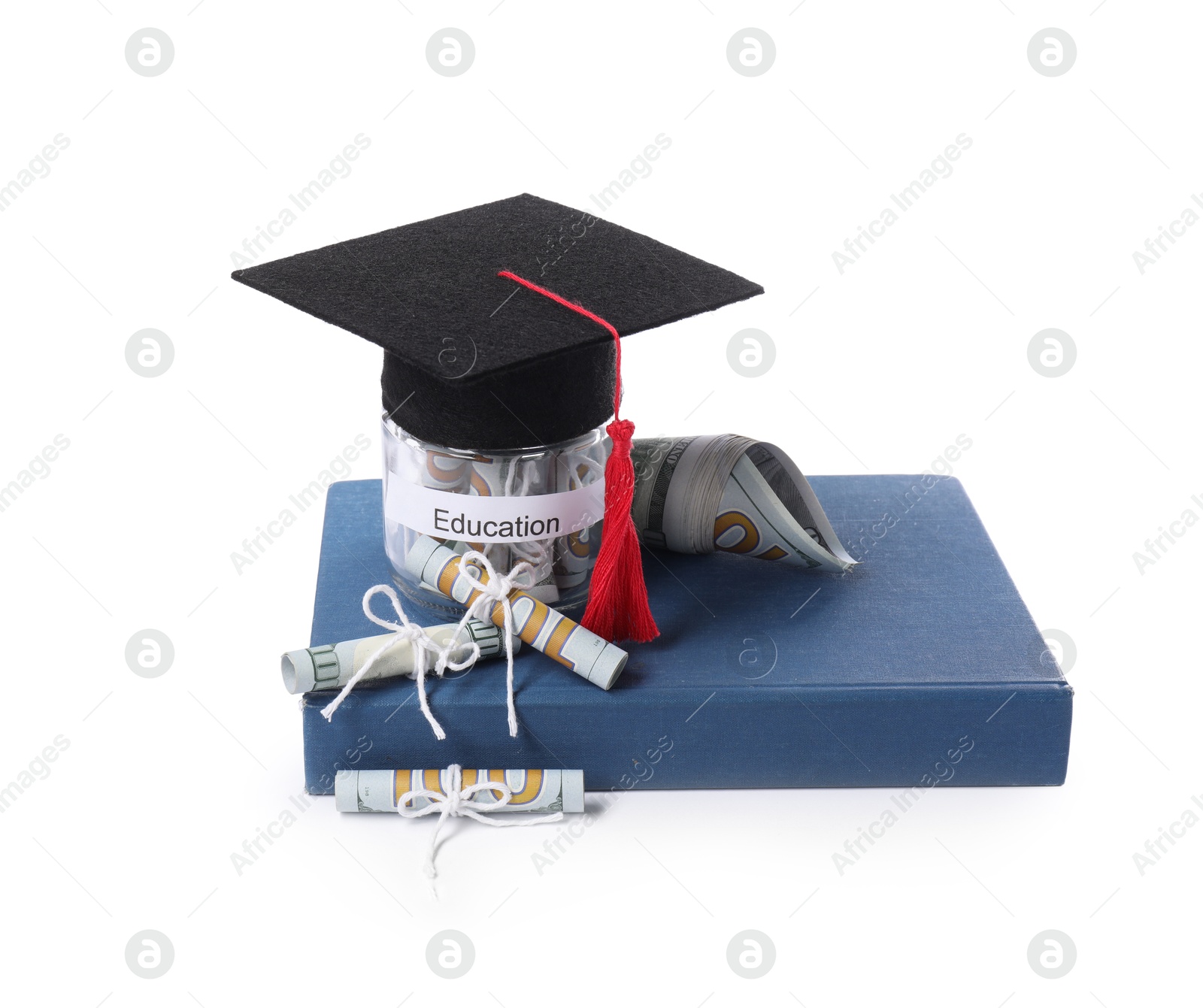 Photo of Graduate hat, dollar banknotes, book and glass jar with word Education isolated on white. Tuition payment