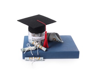 Photo of Graduate hat, dollar banknotes, book and glass jar with word Education isolated on white. Tuition payment