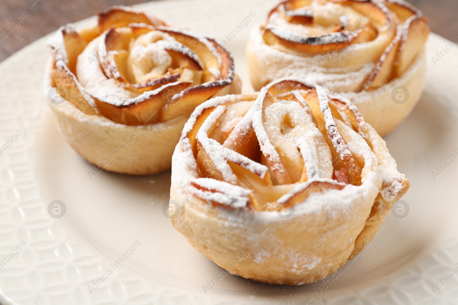 Freshly baked apple roses on plate, closeup Photo of Freshly baked apple roses on plate, closeup