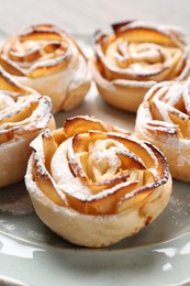 Photo of Freshly baked apple roses on plate, closeup