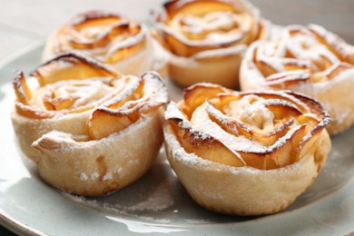 Photo of Freshly baked apple roses on plate, closeup