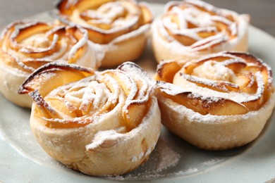 Photo of Freshly baked apple roses on plate, closeup