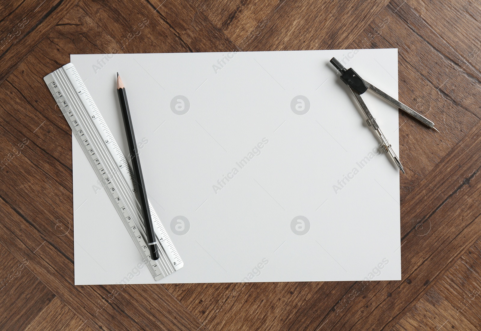 Photo of Ruler, paper, compass and pencil on wooden table, flat lay. Space for text