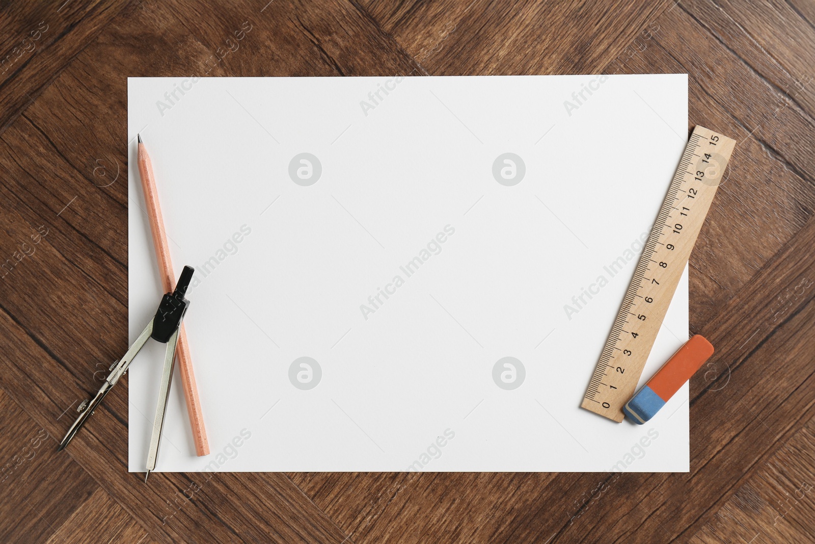 Photo of Ruler, paper, compass, eraser and pencil on wooden table, flat lay. Space for text