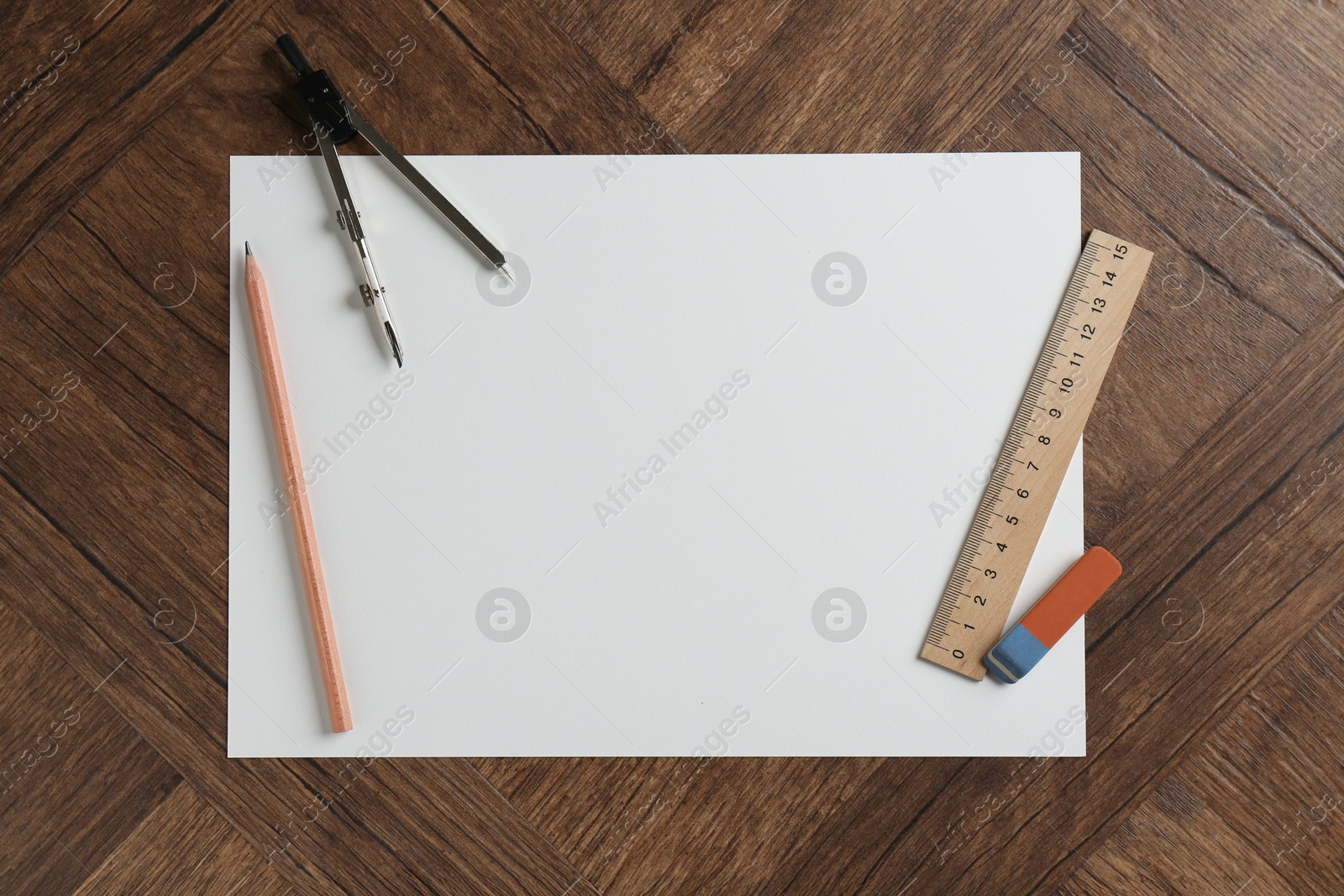 Photo of Ruler, paper, compass, eraser and pencil on wooden table, flat lay. Space for text