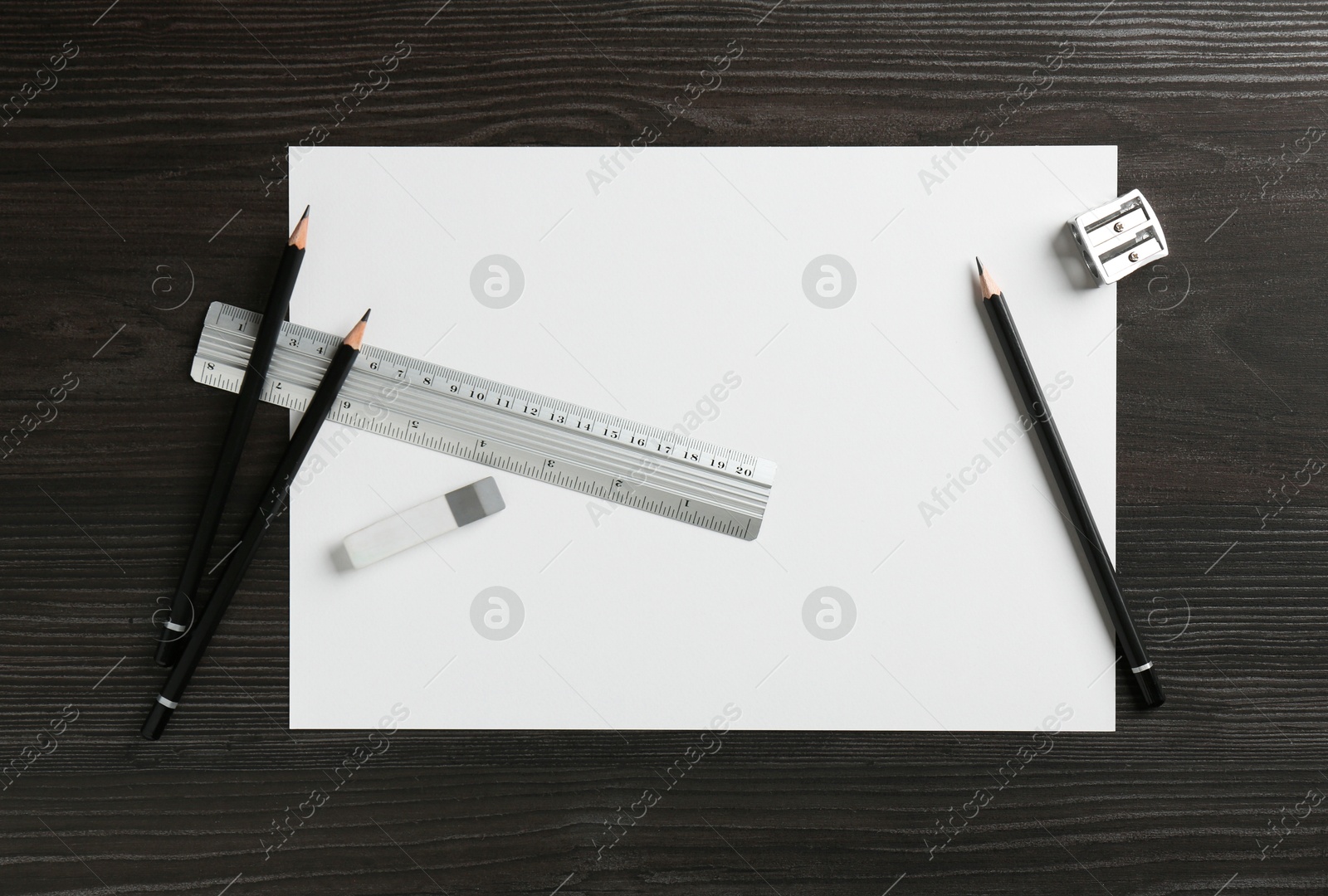 Photo of Ruler, paper and other stationery on black wooden table, flat lay. Space for text