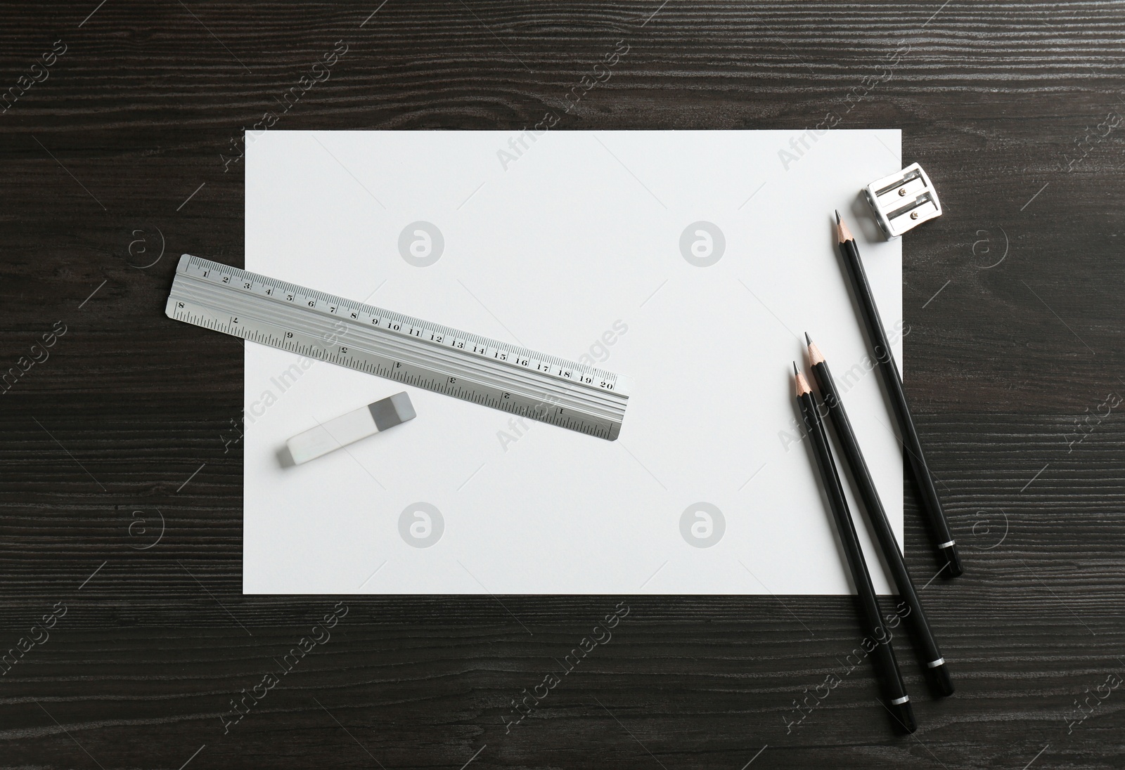 Photo of Ruler, paper and other stationery on black wooden table, flat lay. Space for text