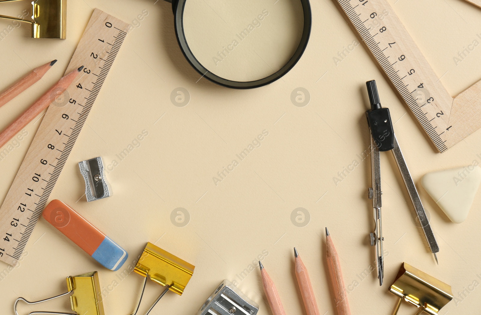 Photo of Flat lay composition with ruler and other stationery on beige background, space for text