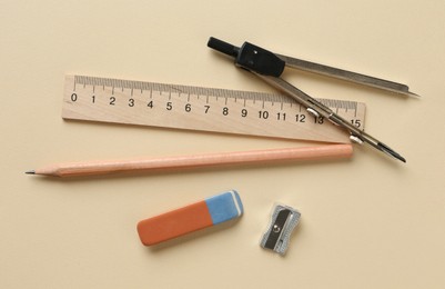 Photo of Ruler and other stationery on beige background, flat lay