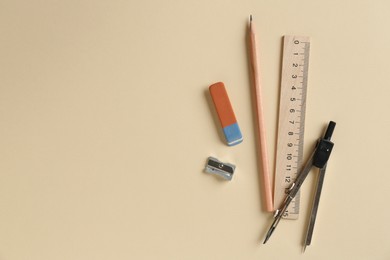 Photo of Flat lay composition with ruler and other stationery on beige background, space for text