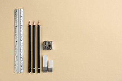 Photo of Flat lay composition with ruler and other stationery on beige background, space for text