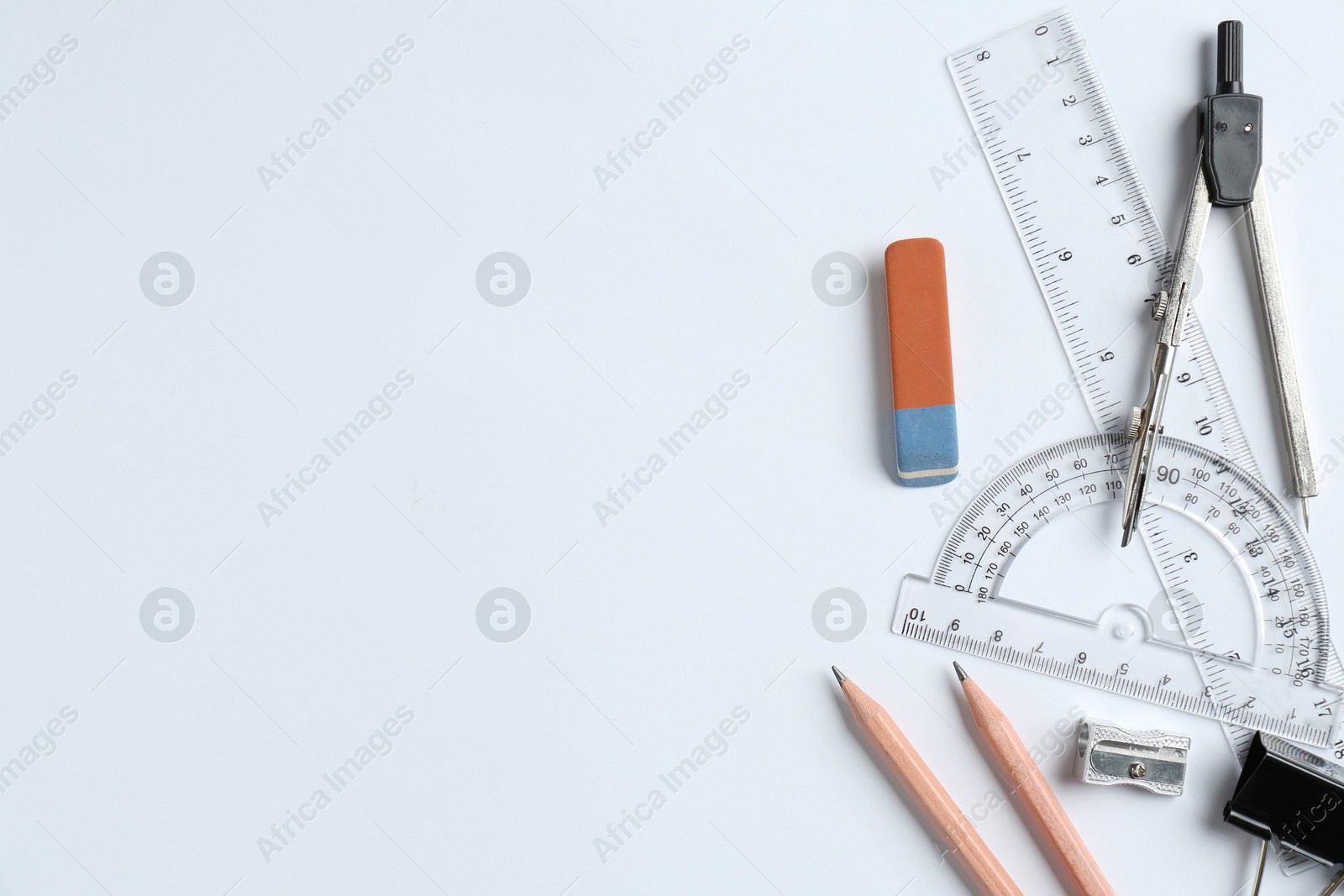 Photo of Flat lay composition with ruler and other stationery on white background, space for text