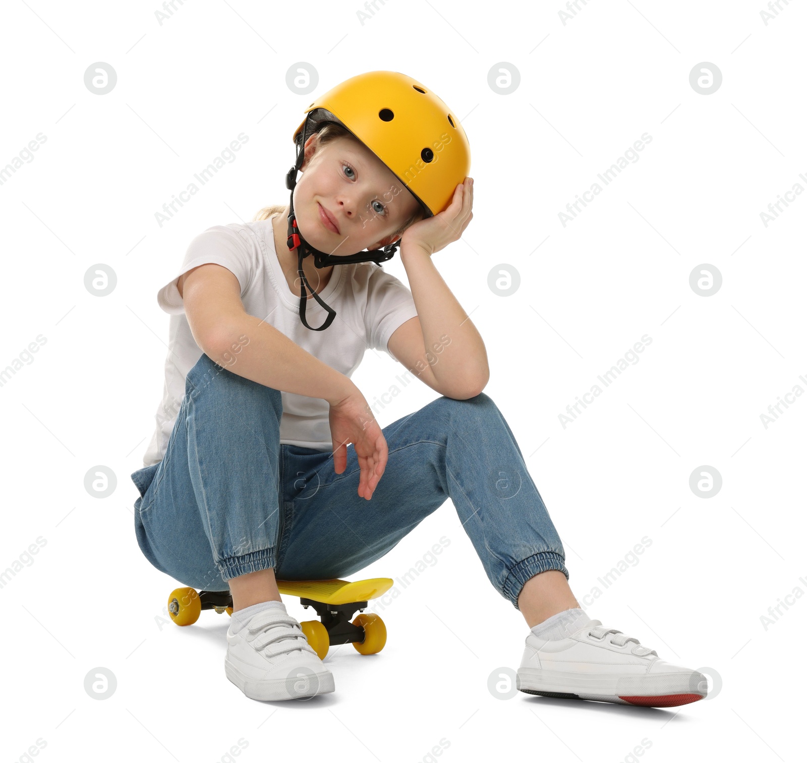 Photo of Little girl in helmet sitting on penny board against white background