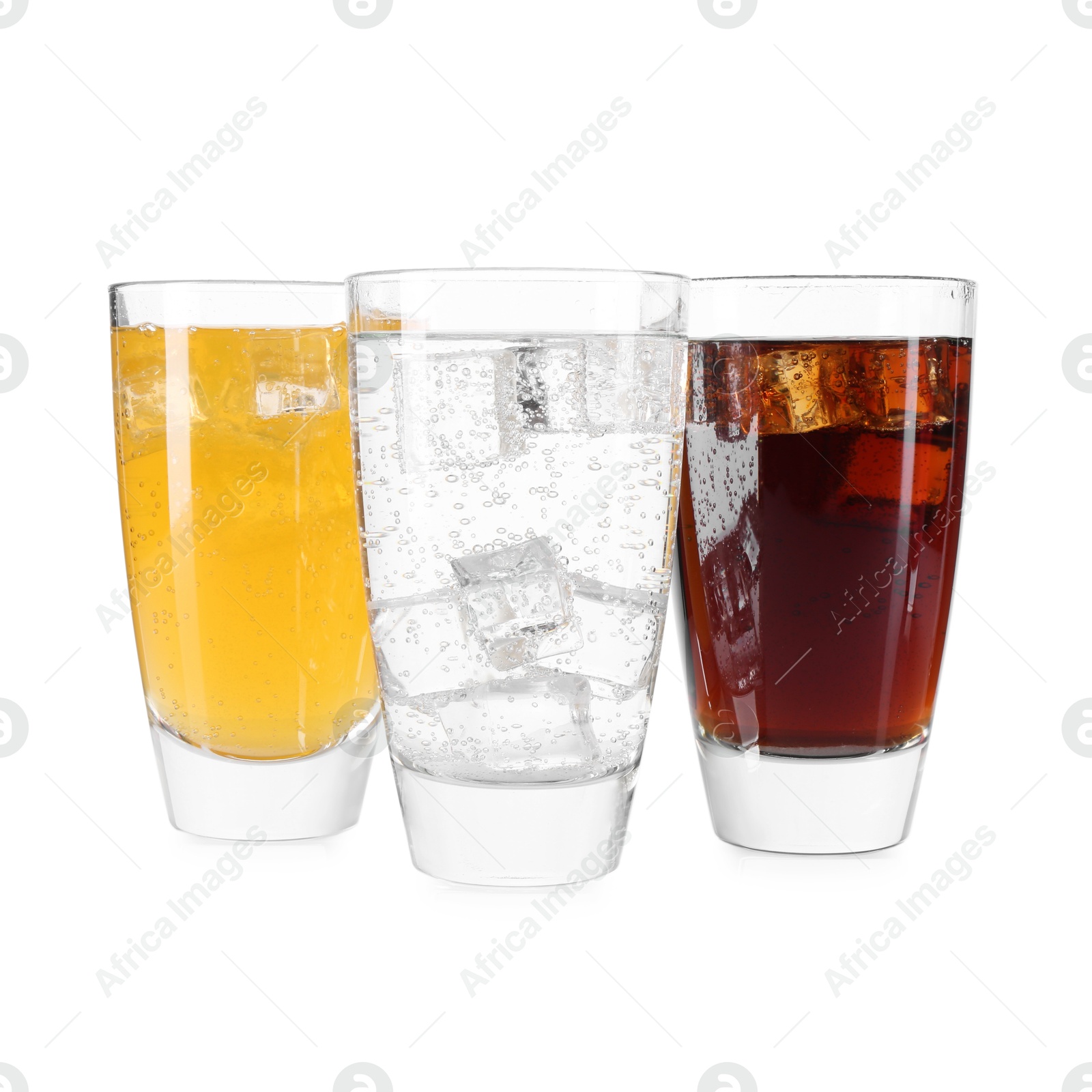 Photo of Soda water of different flavors with ice cubes in glasses isolated on white