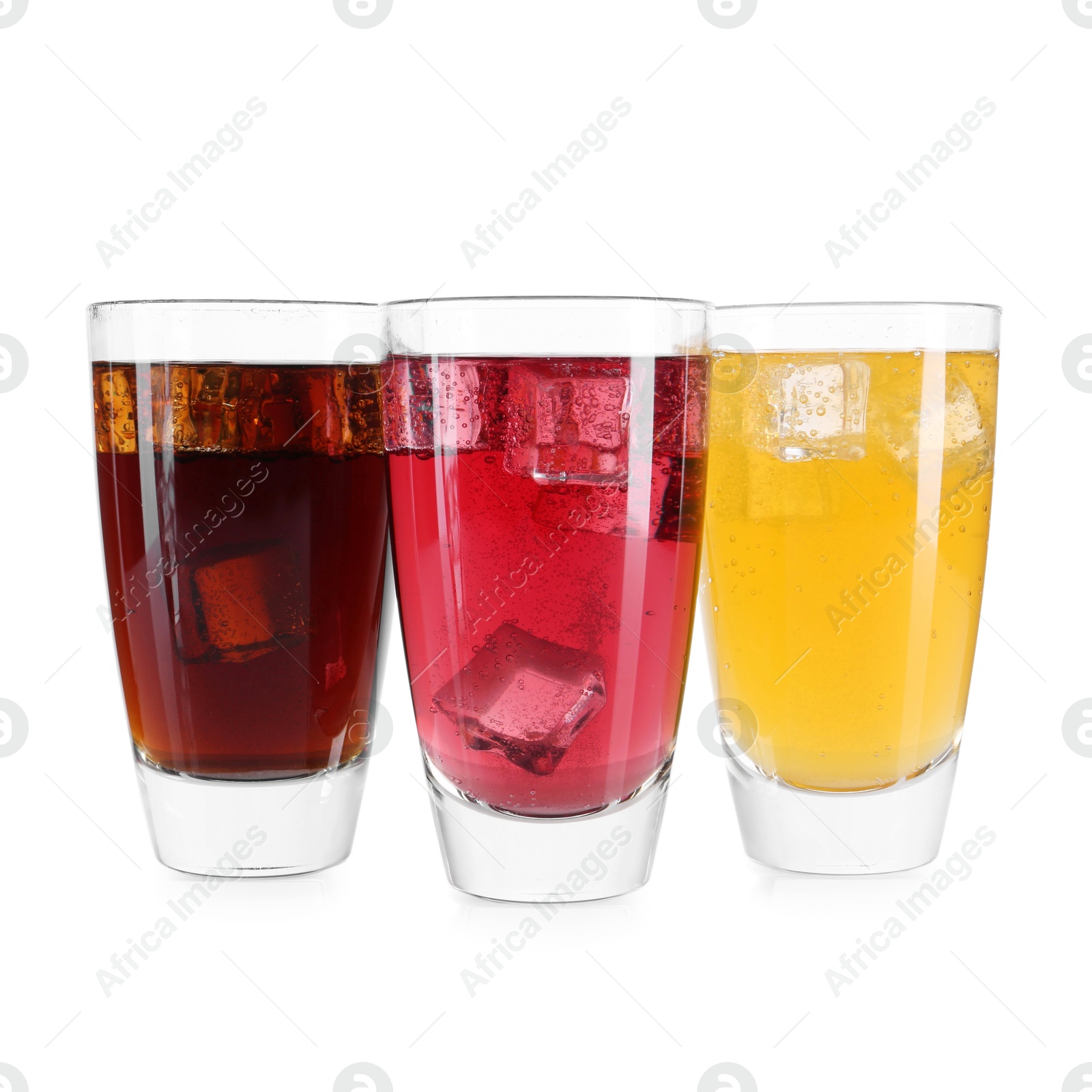 Photo of Soda water of different flavors with ice cubes in glasses isolated on white