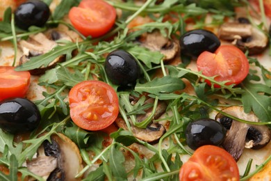 Photo of Tasty pizza with cherry tomatoes, black olives, mushrooms and arugula as background, closeup