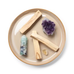 Photo of Palo santo sticks and gemstones isolated on white, top view