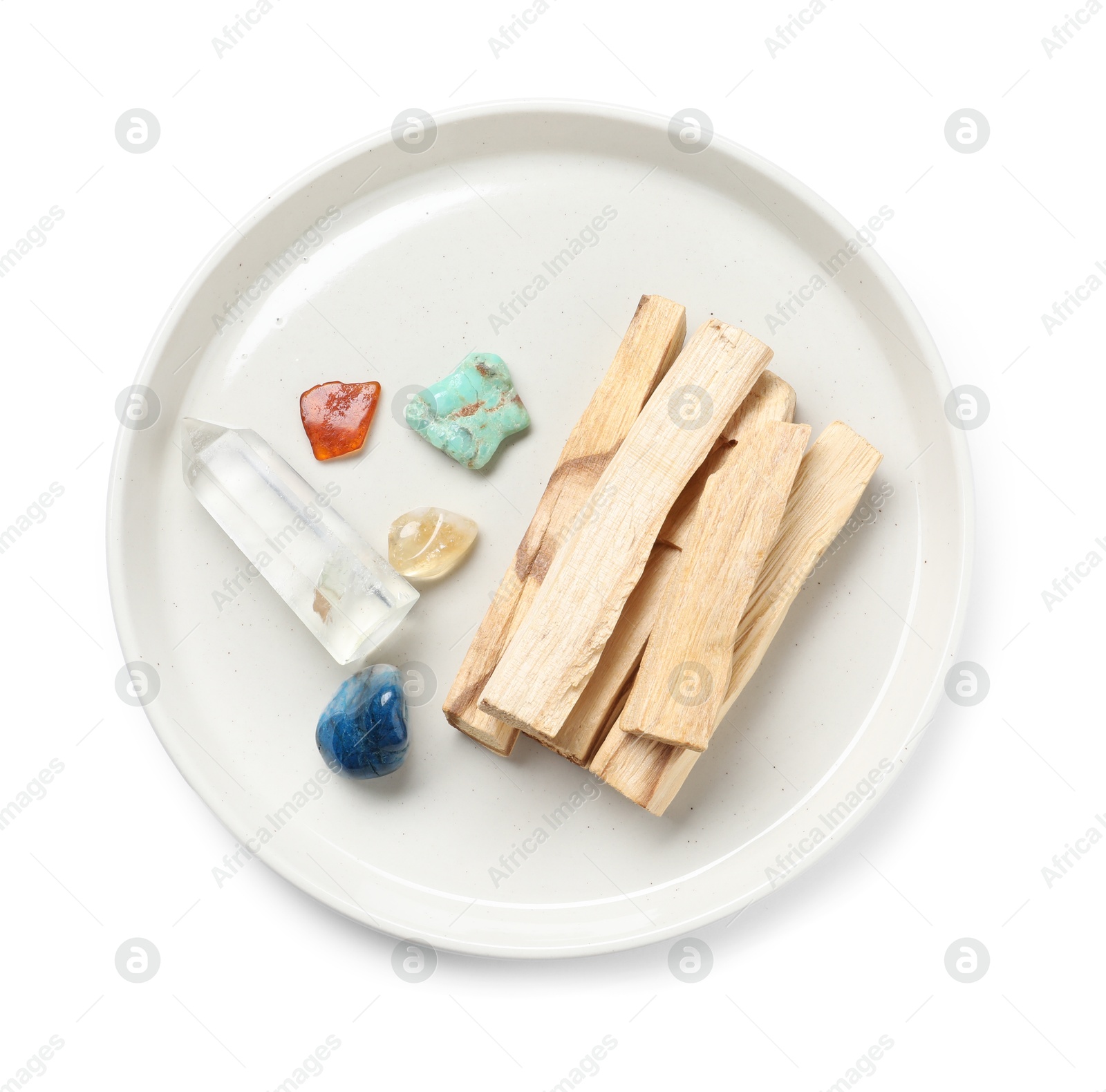 Photo of Palo santo sticks and gemstones isolated on white, top view