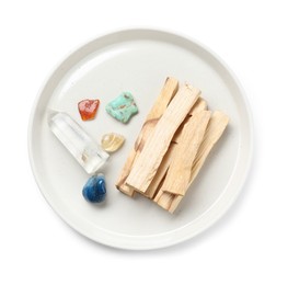 Photo of Palo santo sticks and gemstones isolated on white, top view