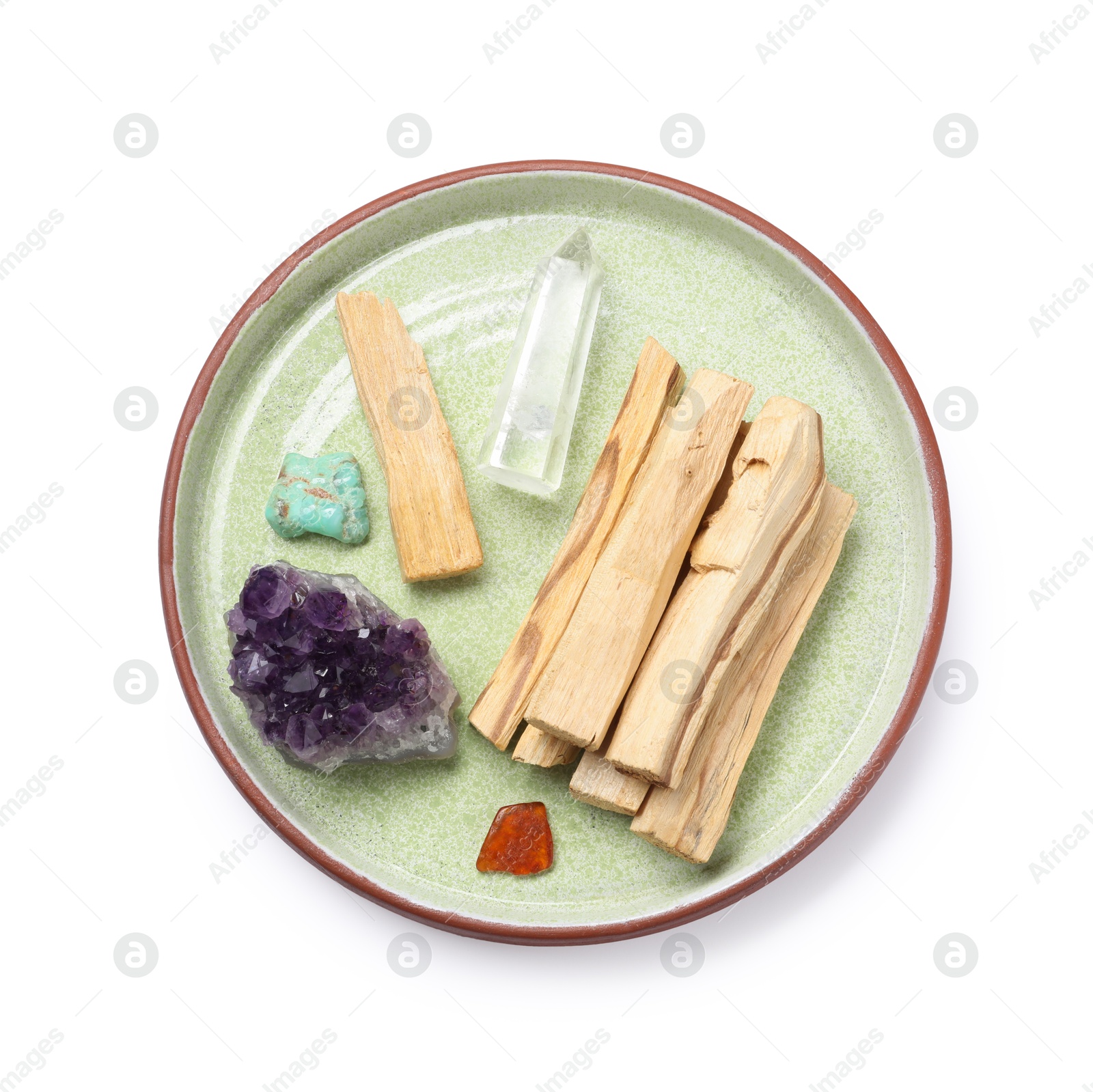 Photo of Palo santo sticks and gemstones isolated on white, top view