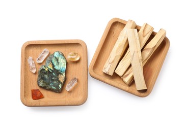 Photo of Palo santo sticks and gemstones isolated on white, top view