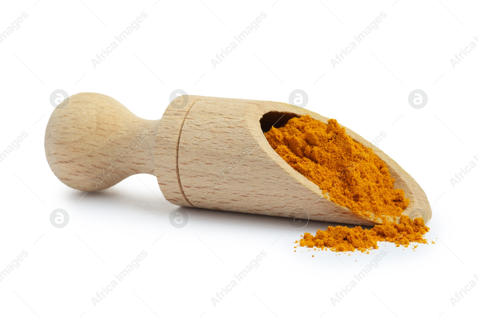 Photo of Turmeric powder in wooden scoop isolated on white