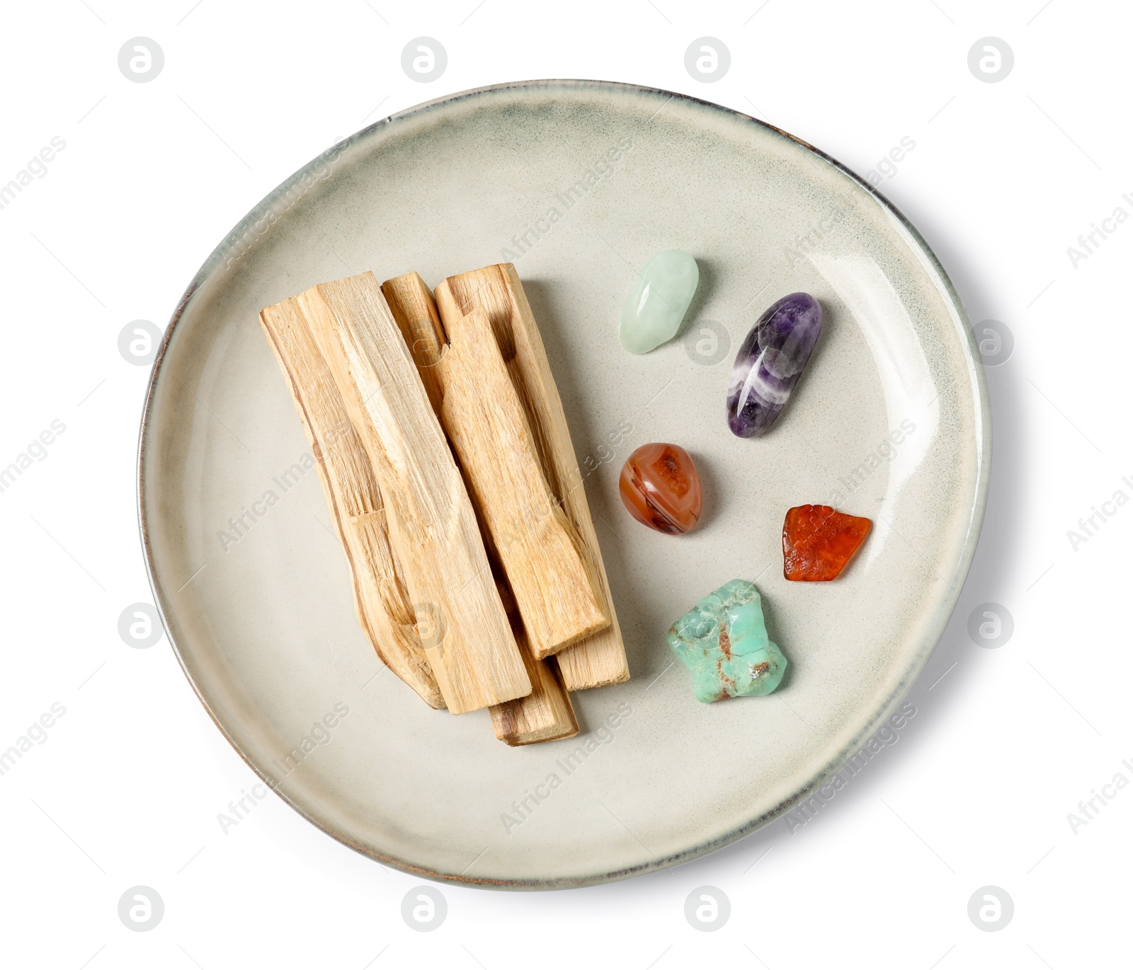 Photo of Palo santo sticks and gemstones isolated on white, top view