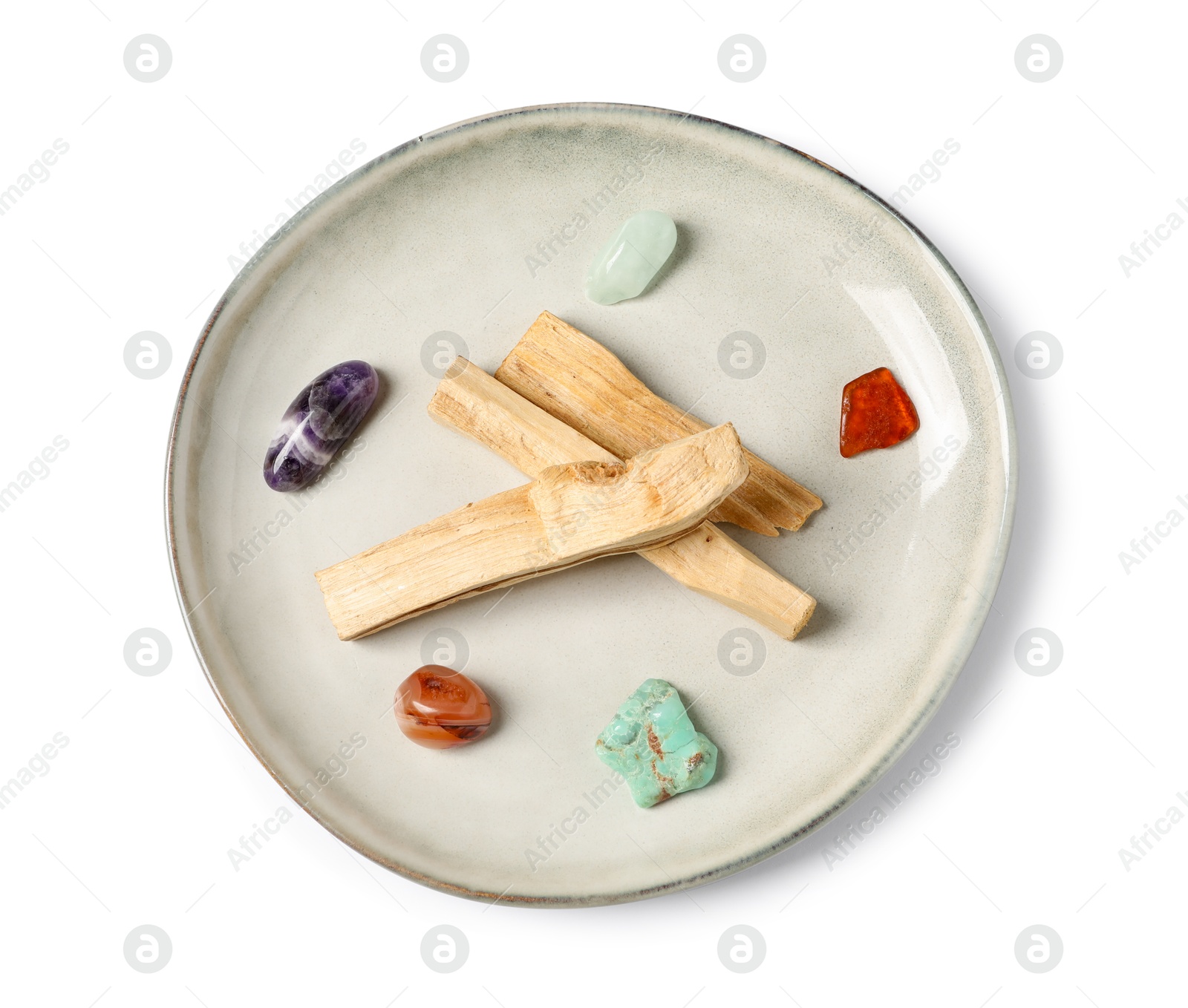 Photo of Palo santo sticks and gemstones isolated on white, top view