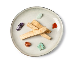 Photo of Palo santo sticks and gemstones isolated on white, top view