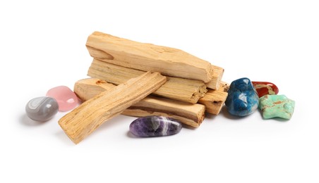 Photo of Palo santo sticks and gemstones isolated on white