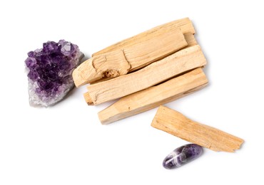 Photo of Palo santo sticks and gemstones isolated on white, top view