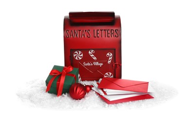 Photo of Santa Claus mail box with letters, gift and artificial snow isolated on white. Christmas tradition