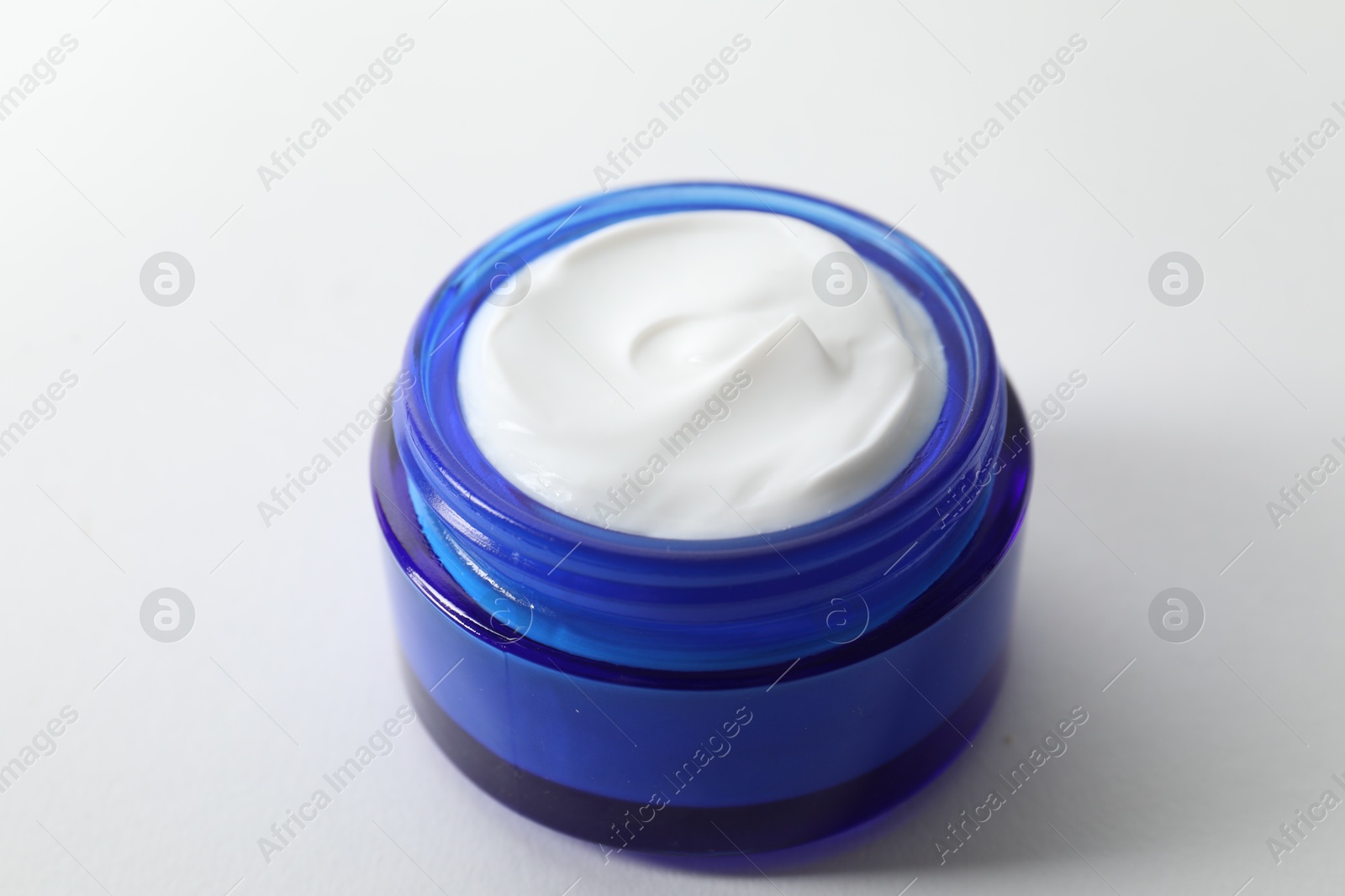 Photo of Jar of cream on white background, closeup