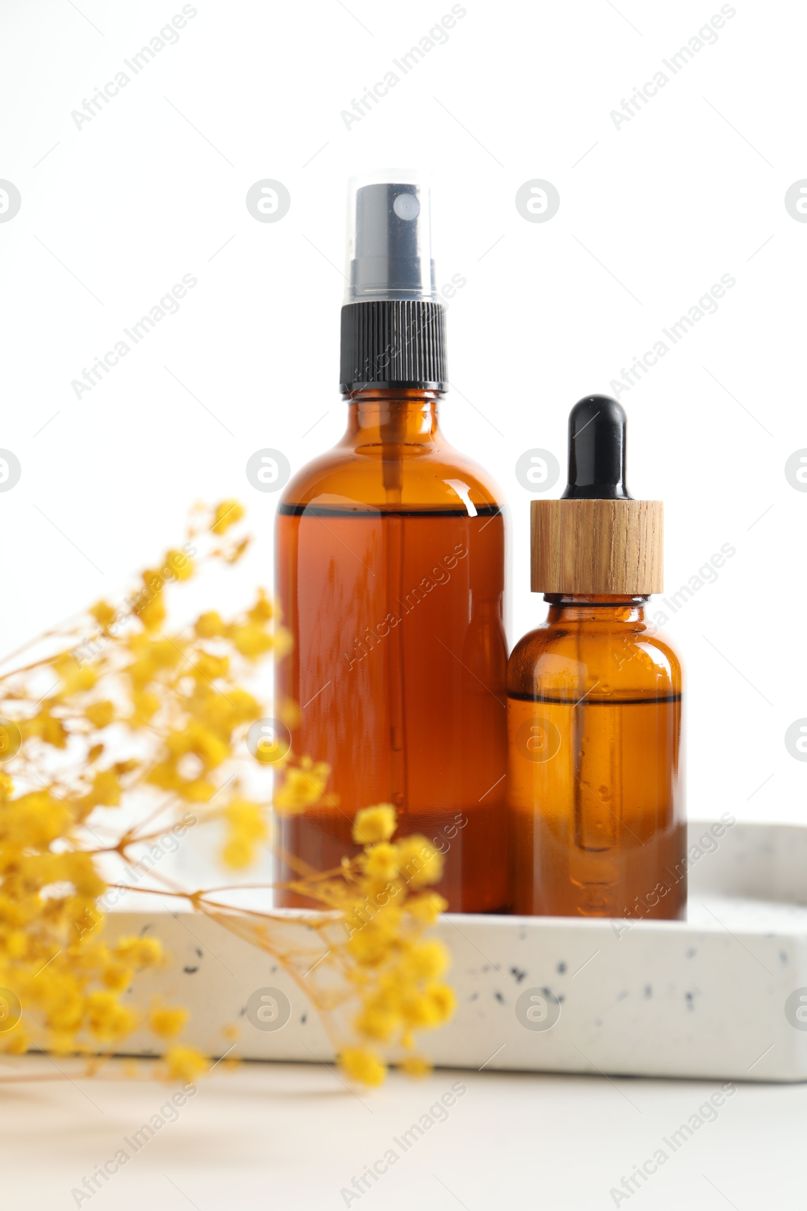 Photo of Different cosmetic products and gypsophila flowers on white background