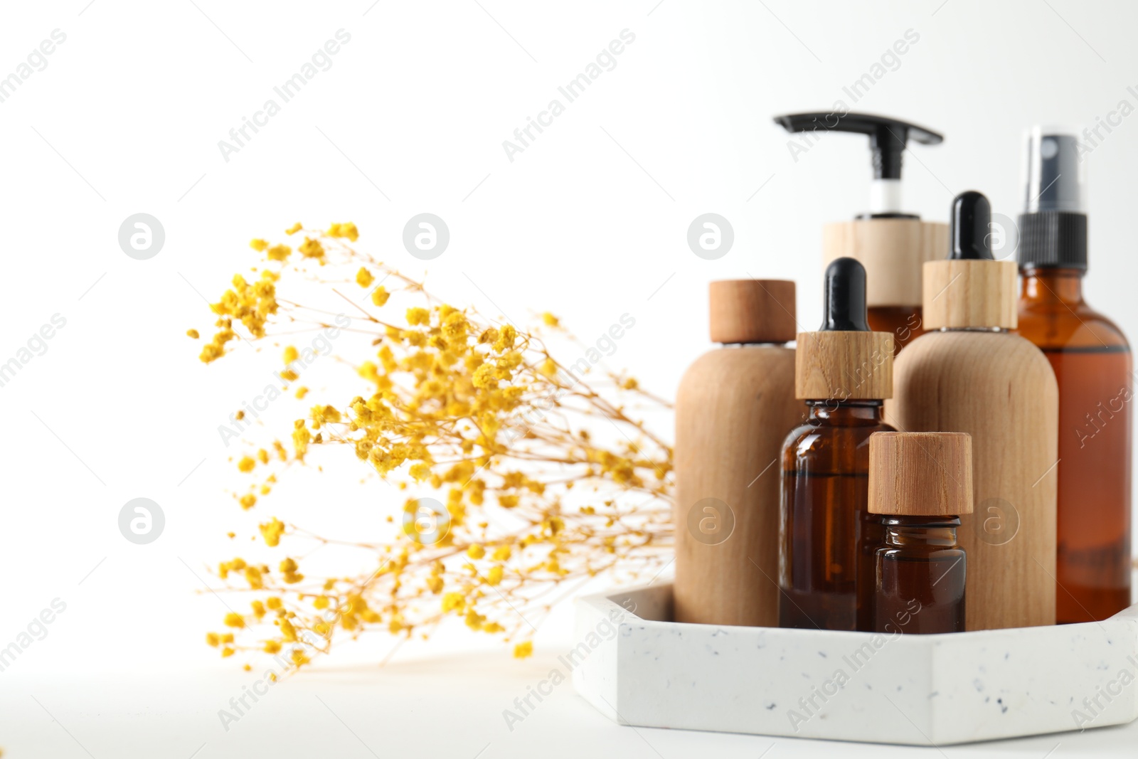 Photo of Different cosmetic products and gypsophila flowers on white background