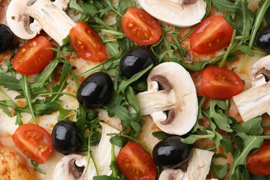 Photo of Tasty pizza with cherry tomatoes, black olives, mushrooms and arugula as background, top view