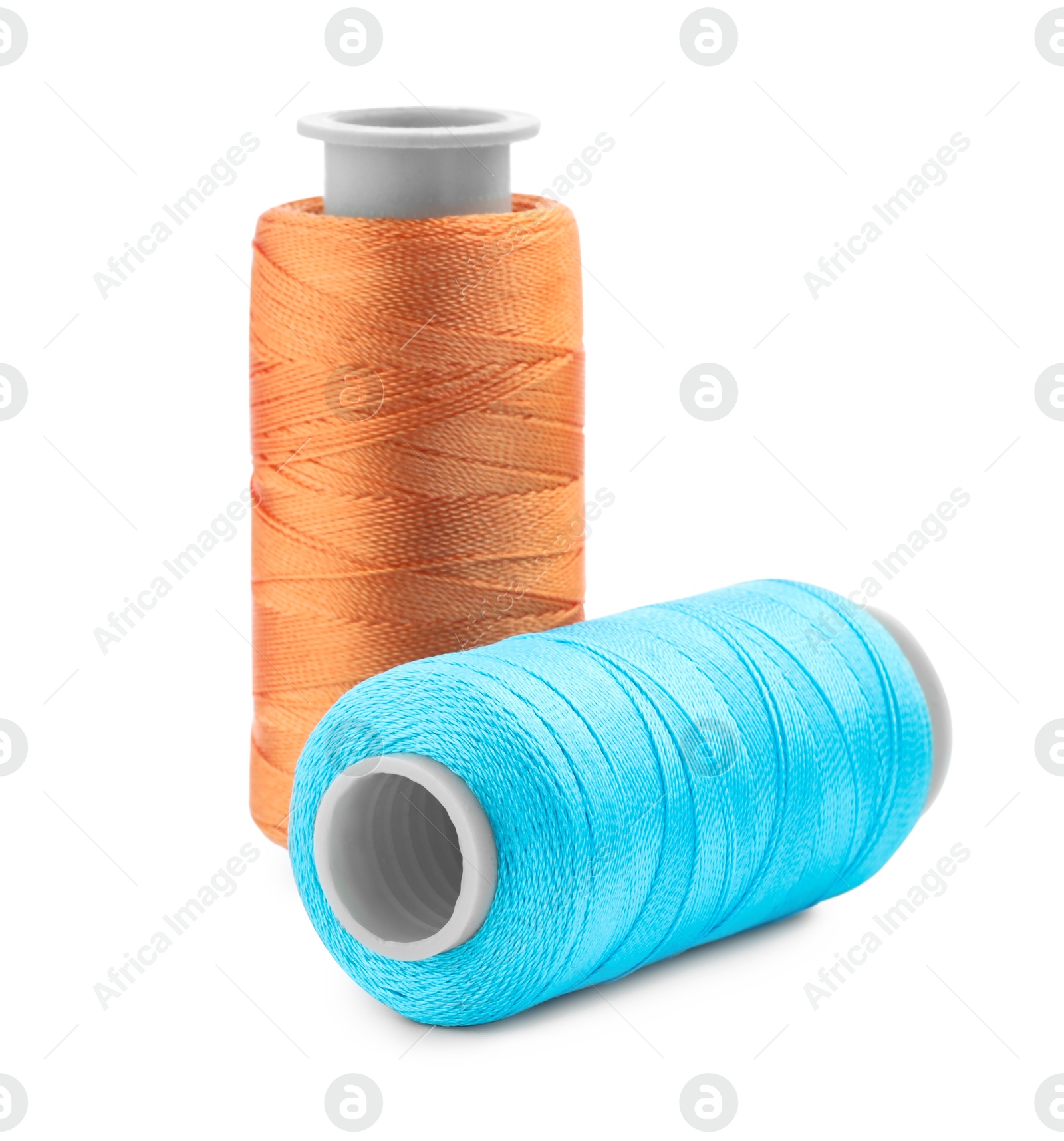 Photo of Spools of bright sewing threads isolated on white