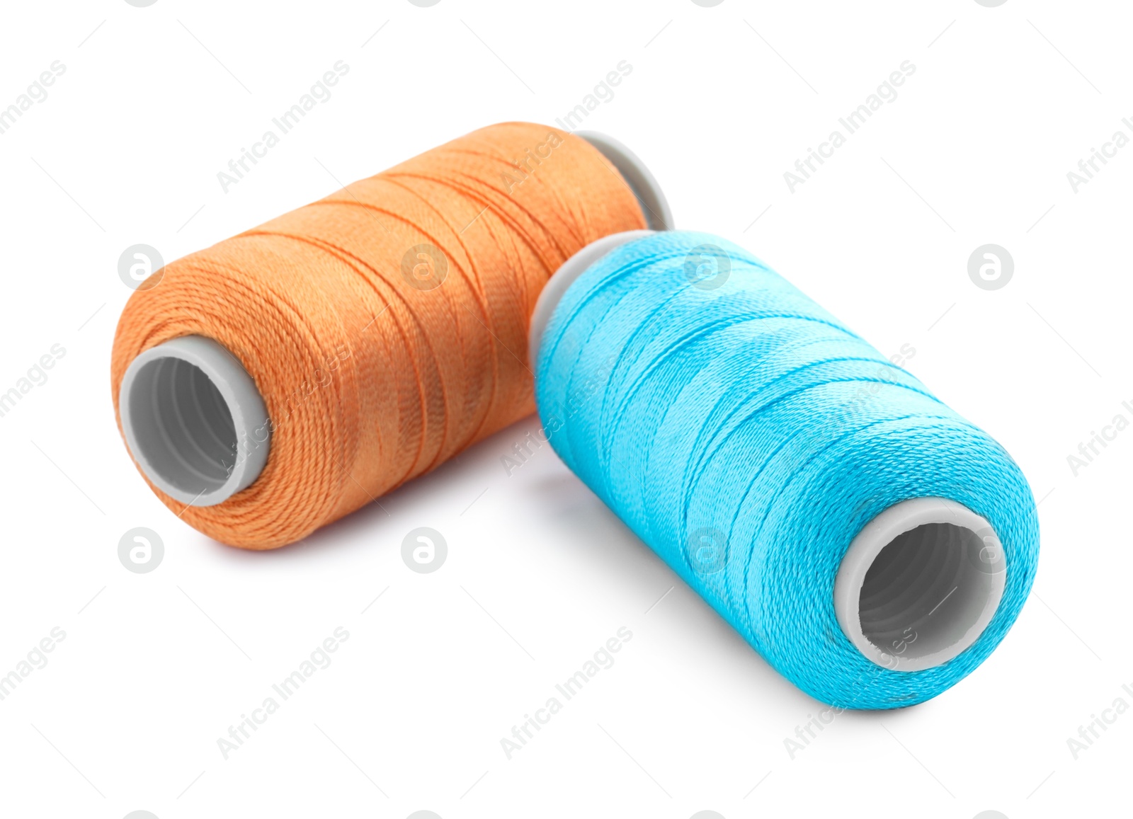 Photo of Spools of bright sewing threads isolated on white