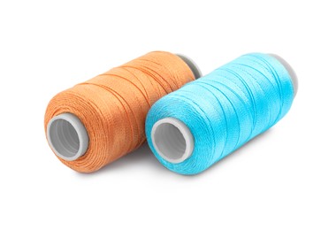 Photo of Spools of bright sewing threads isolated on white