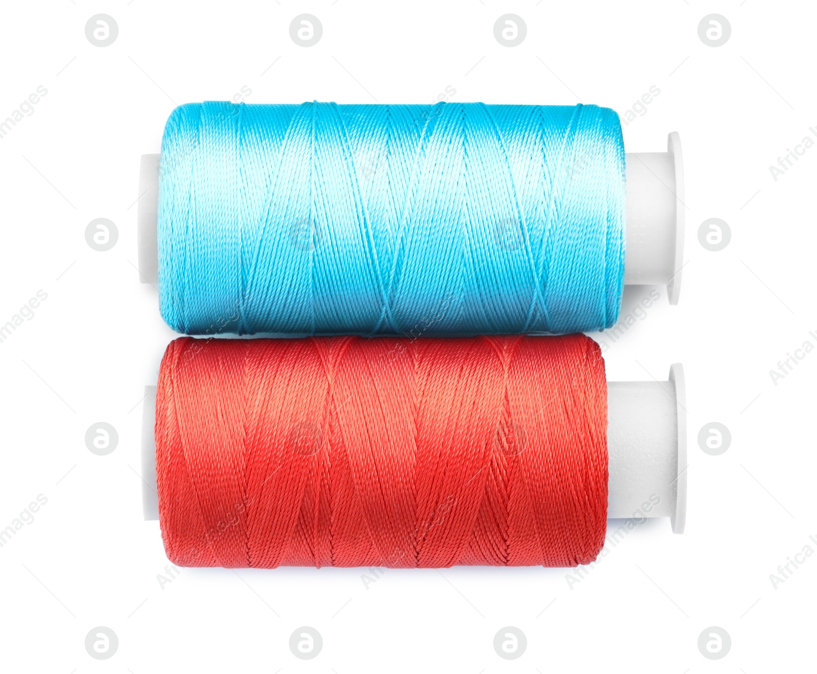 Photo of Spools of bright sewing threads isolated on white, top view