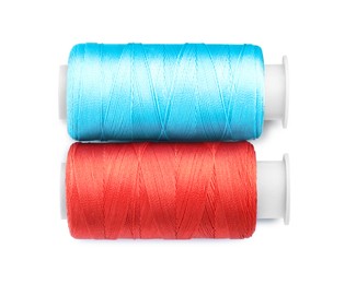 Photo of Spools of bright sewing threads isolated on white, top view