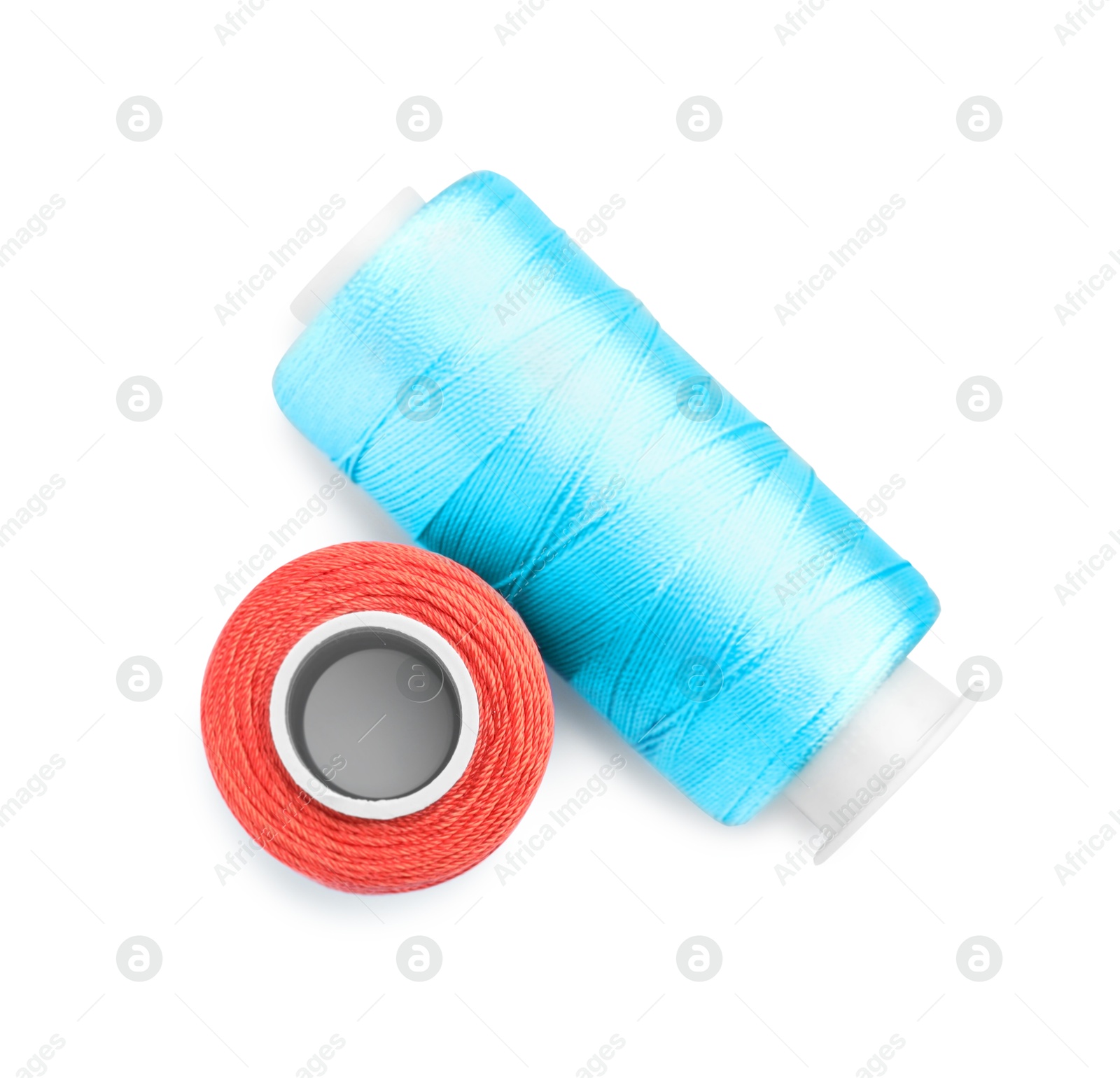 Photo of Spools of bright sewing threads isolated on white, top view