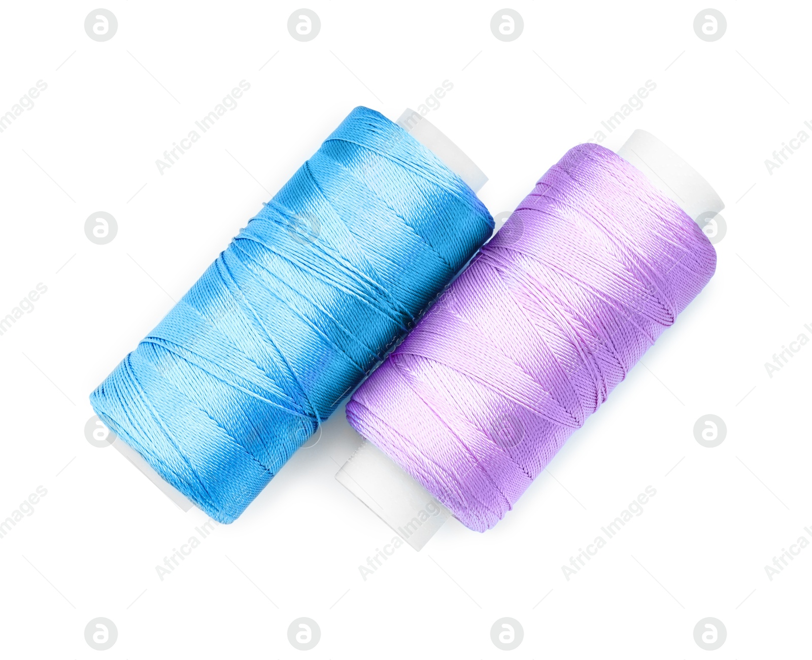 Photo of Spools of bright sewing threads isolated on white, top view