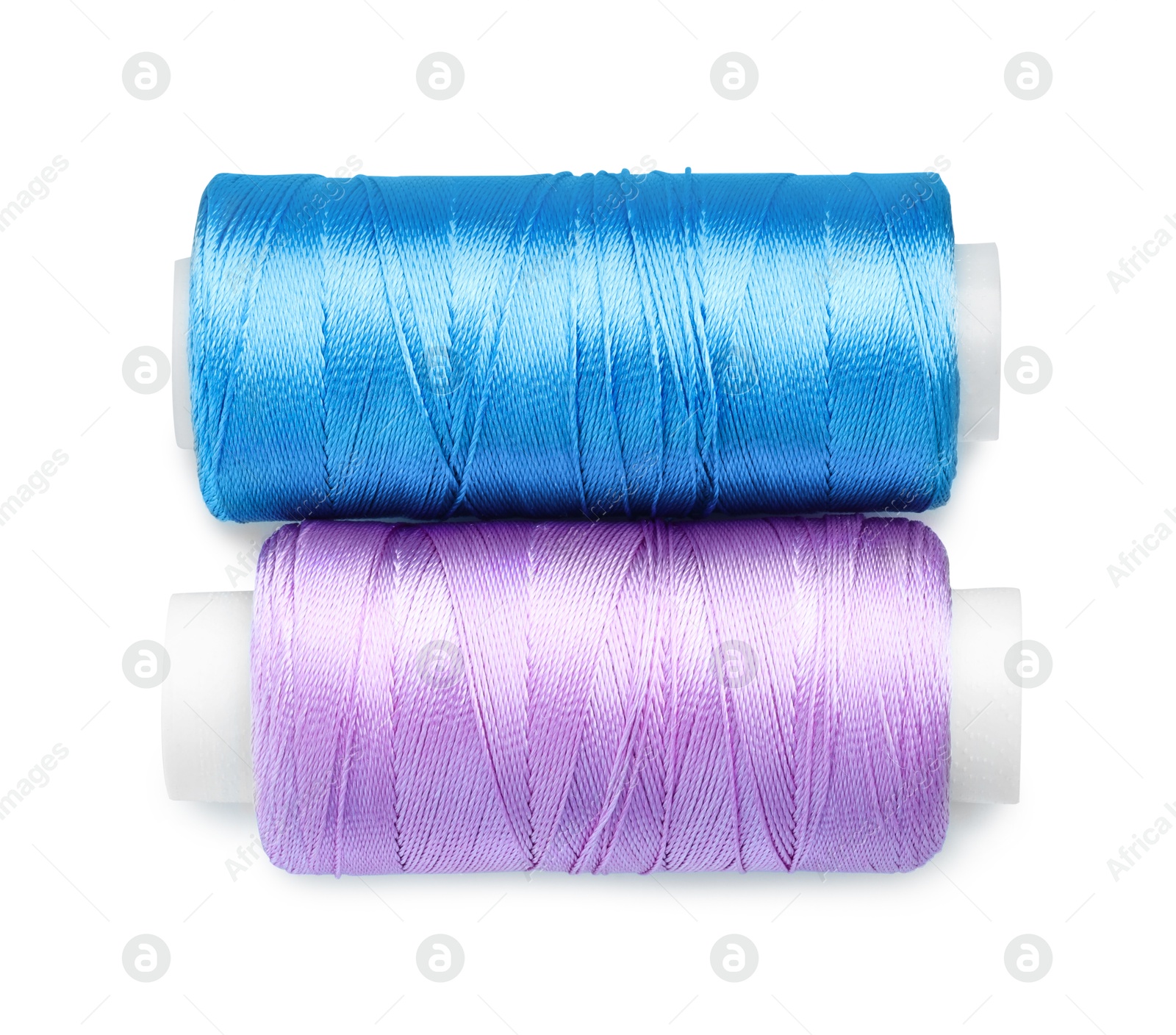 Photo of Spools of bright sewing threads isolated on white, top view