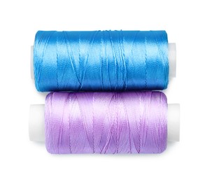 Photo of Spools of bright sewing threads isolated on white, top view