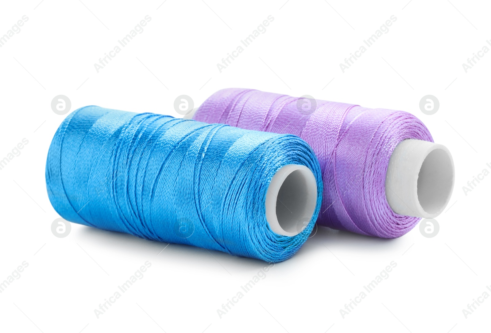 Photo of Spools of bright sewing threads isolated on white