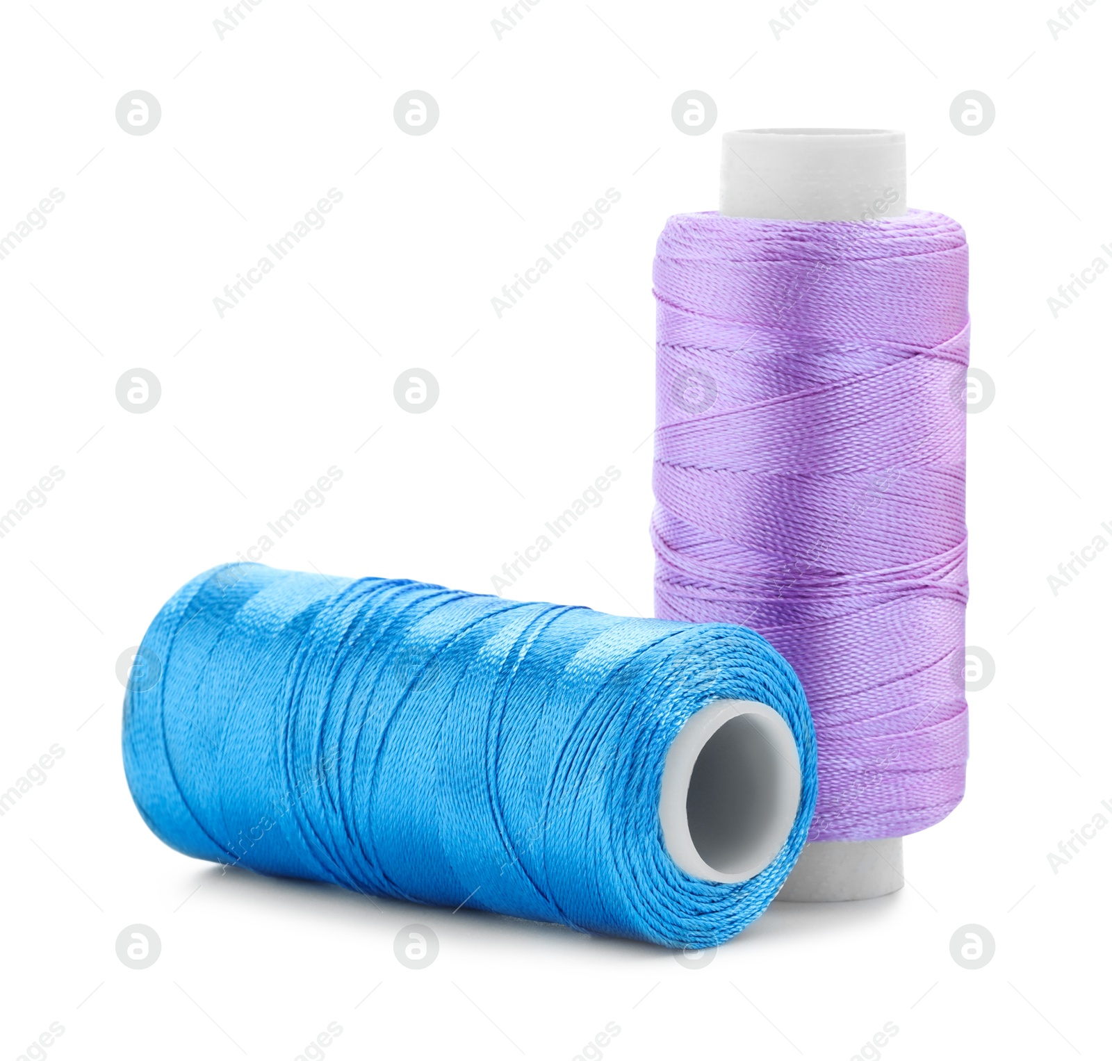 Photo of Spools of bright sewing threads isolated on white