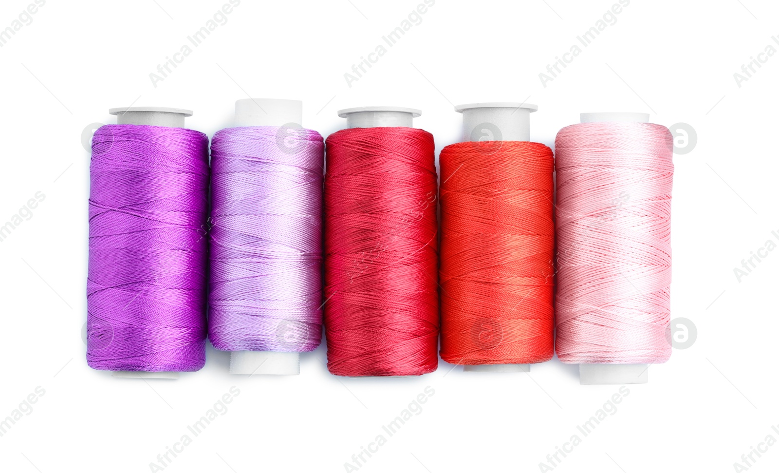 Photo of Spools of bright sewing threads isolated on white, top view